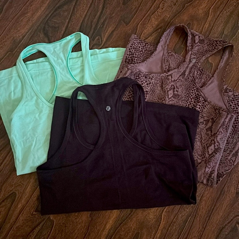 Three Lululemon yoga tanks. Fits size medium. Good condition.